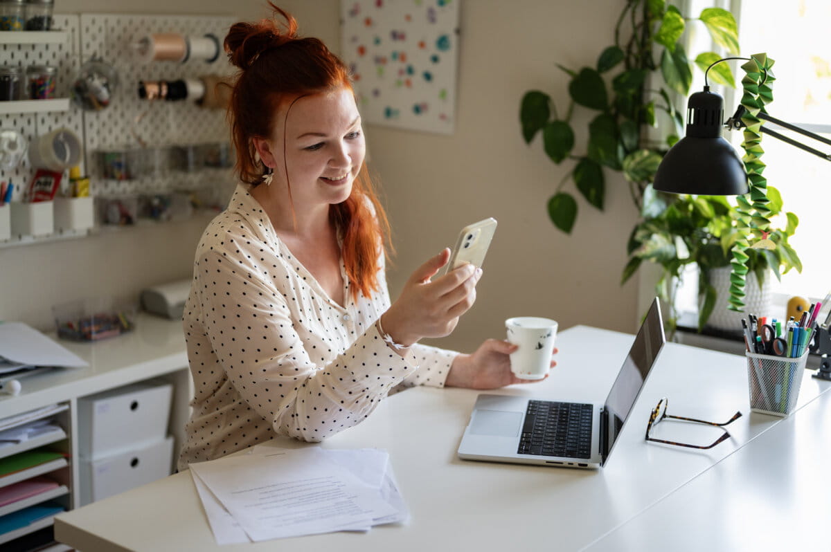 Woman sitting with phone in her hand